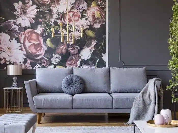 Stylish grey sofa with round cushion, soft throw, and modern decor in a sophisticated living room setting.