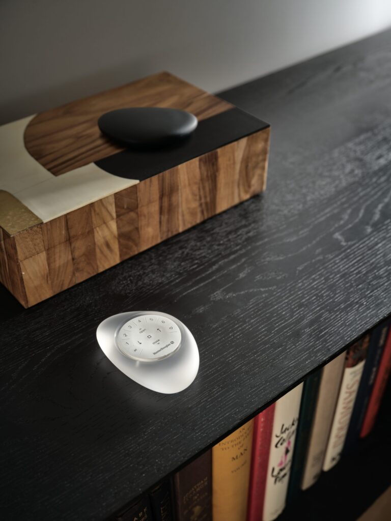 Hunter Douglas PowerView® Pebble® Remote on a side table